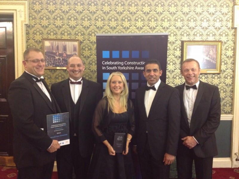 The team join Cllr Mahroof Hussain after winning the training award