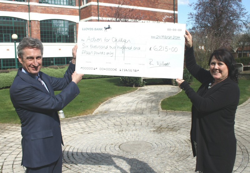 Rick Willmott presents a big cheque to Action for Children's Madeleine Clarke