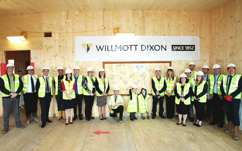 Willmott Dixon & Old Bexley School staff at the wall signing alongside local pupils